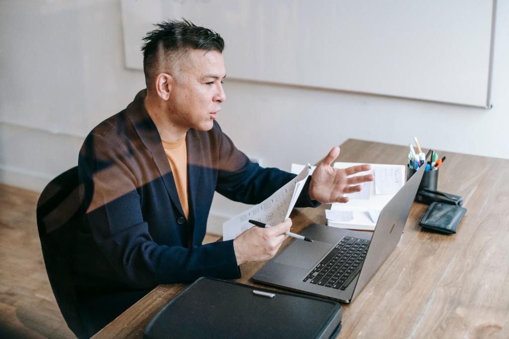 Legal professional reviewing documents at a desk during a consultation